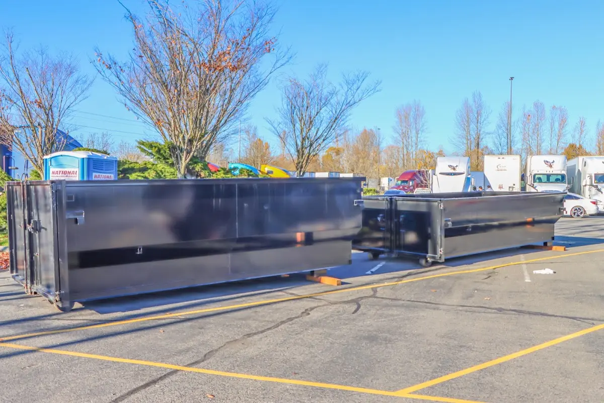 Professional dumpster rental service with roll-off container on residential driveway in Horn Lake